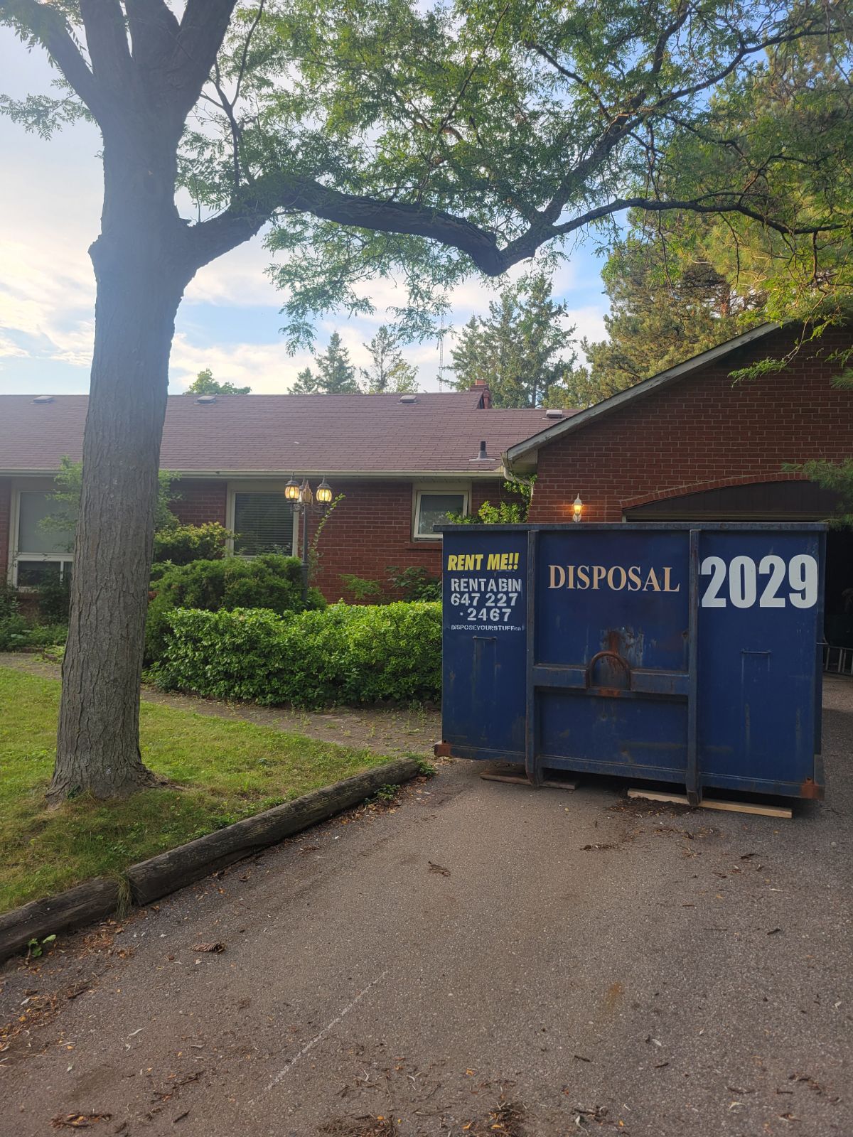 Dumpster bin placed in a residential driveway