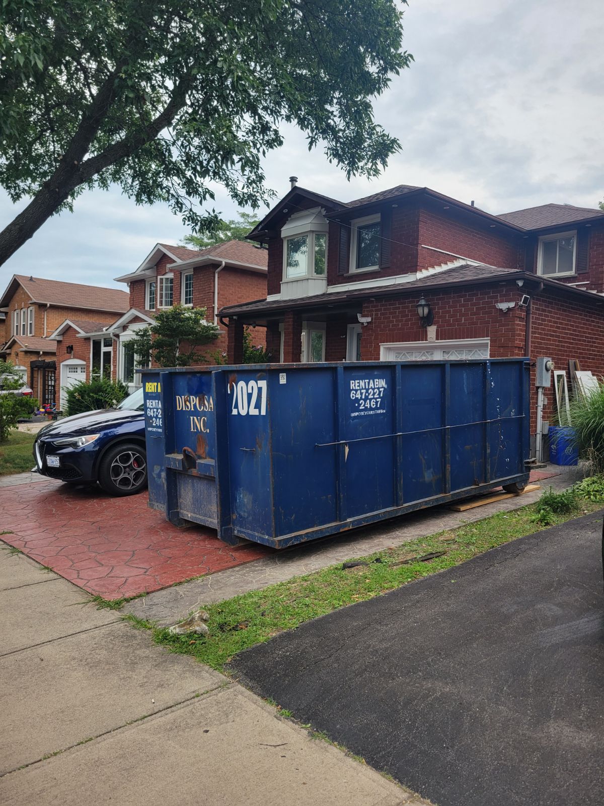 Roll-off bin on residential driveway
