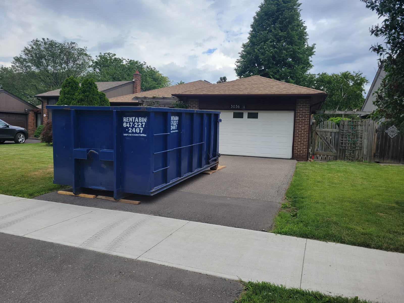 Dumpster positioned on private driveway in Oakville