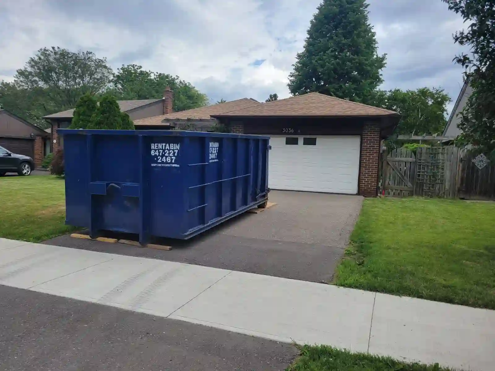 Dumpster tucked safely on a Burlington driveway