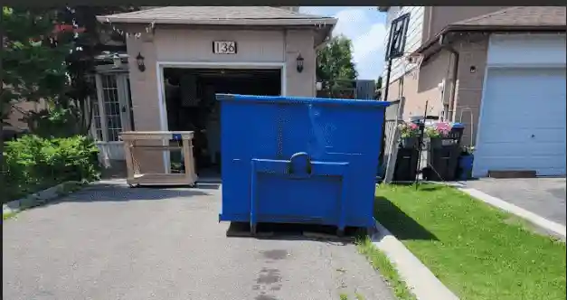 Bin rental placed properly in a residential driveway during renovation