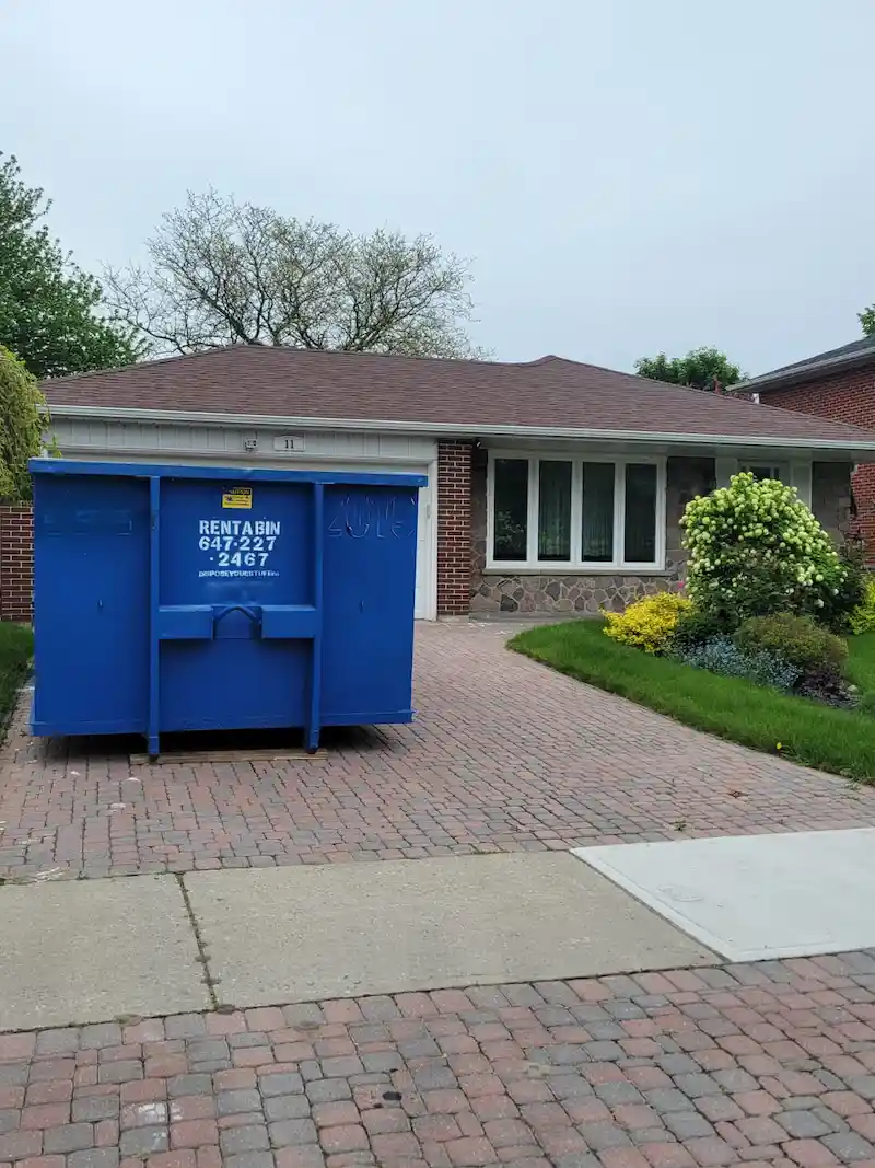 Dumpster neatly placed on a driveway in North York