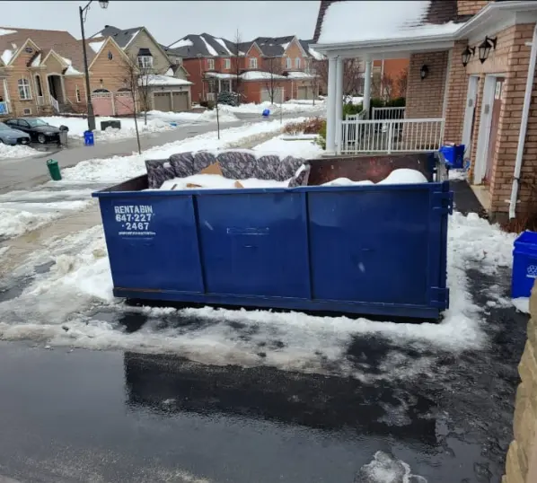 Inspector measuring dumpster clearance in Richmond Hill
