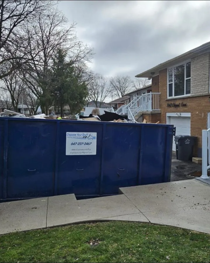 Professional junk removal loading with property protection