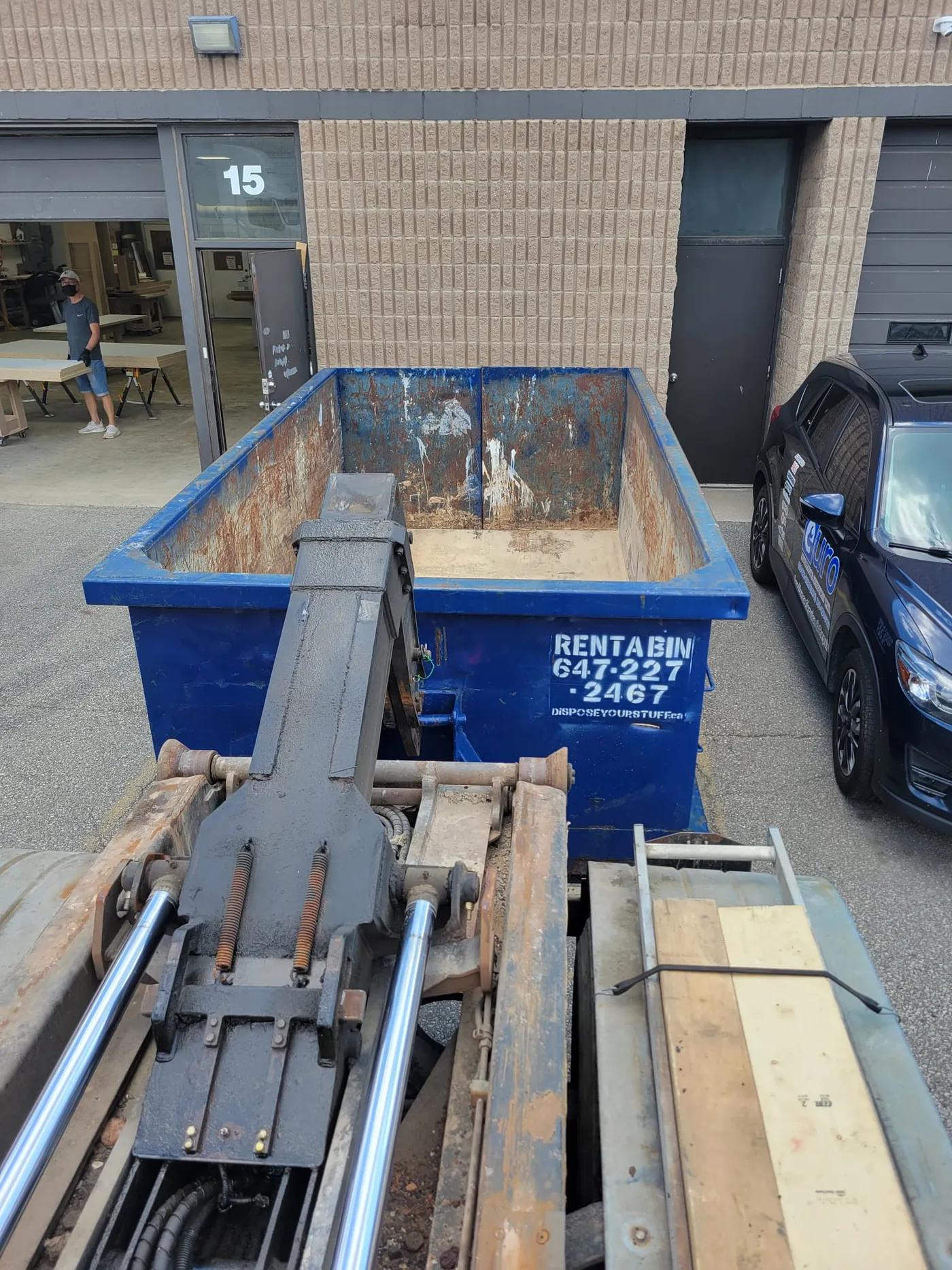 Roll-off hoist loading a bin in Toronto